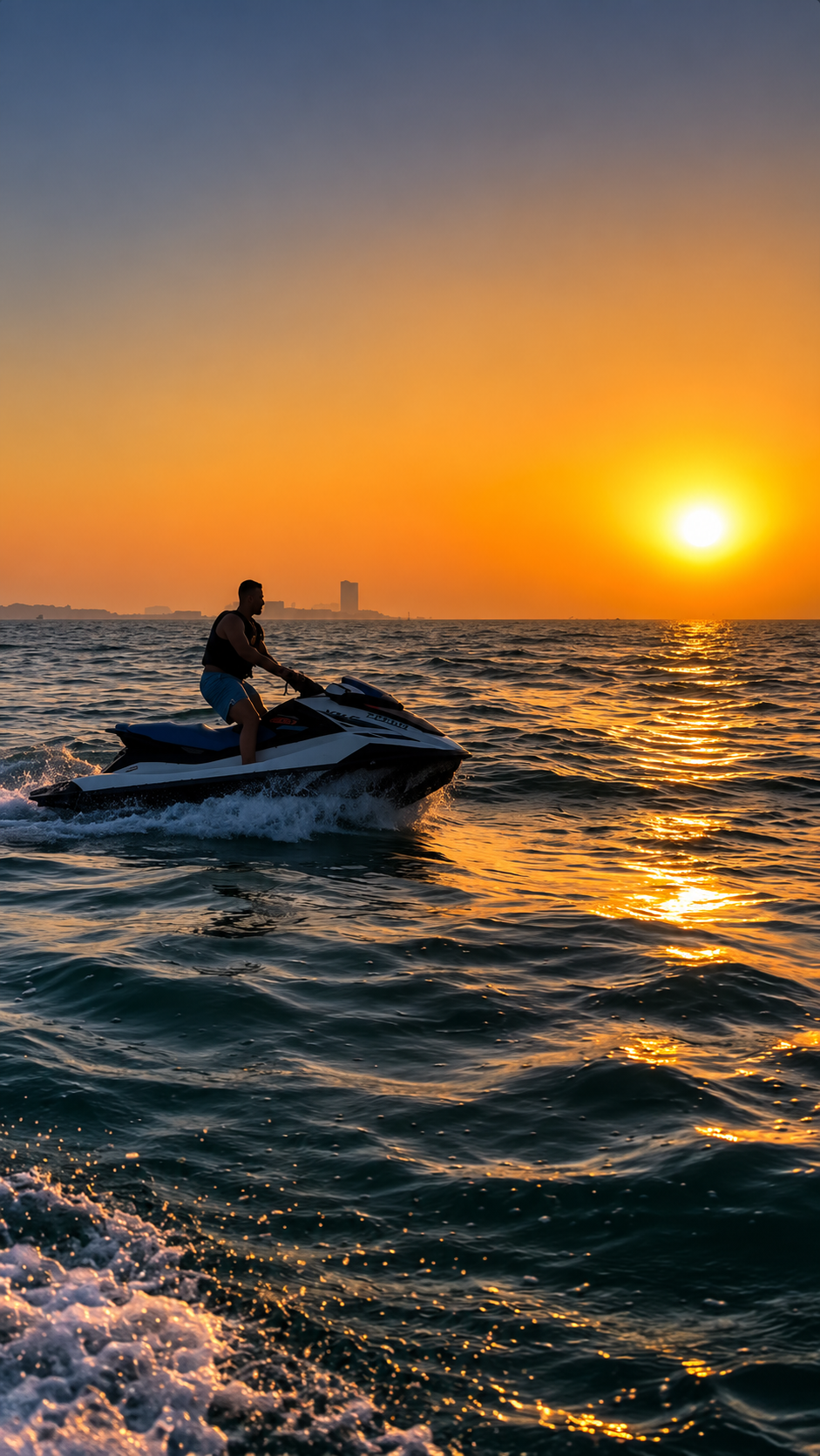 Chris riding a jet ski at sunset